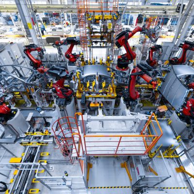 Assembly line production of new car. Automated welding of car body on production line. robotic arm on car production line is working